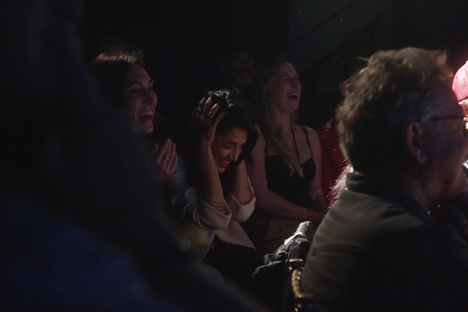 The audience laughing together during the show at Obscenity Bar