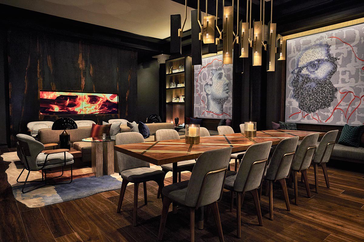 Communal table by the fireplace at Obscenity Bar